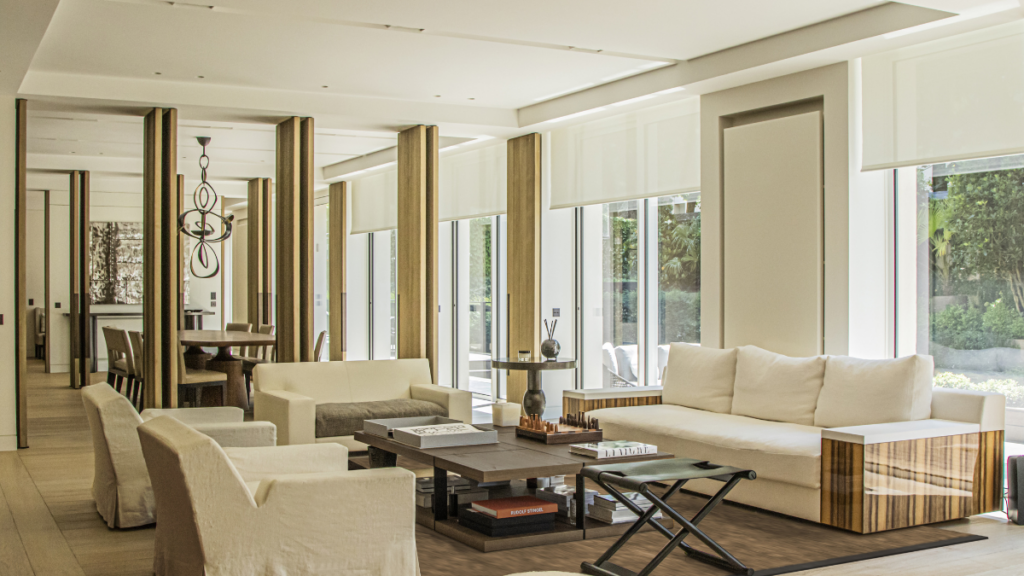 High-end living room with bespoke furniture, wood detailing and large windows in Neuilly near Paris.